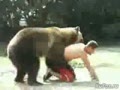 Человек играется с медведем.